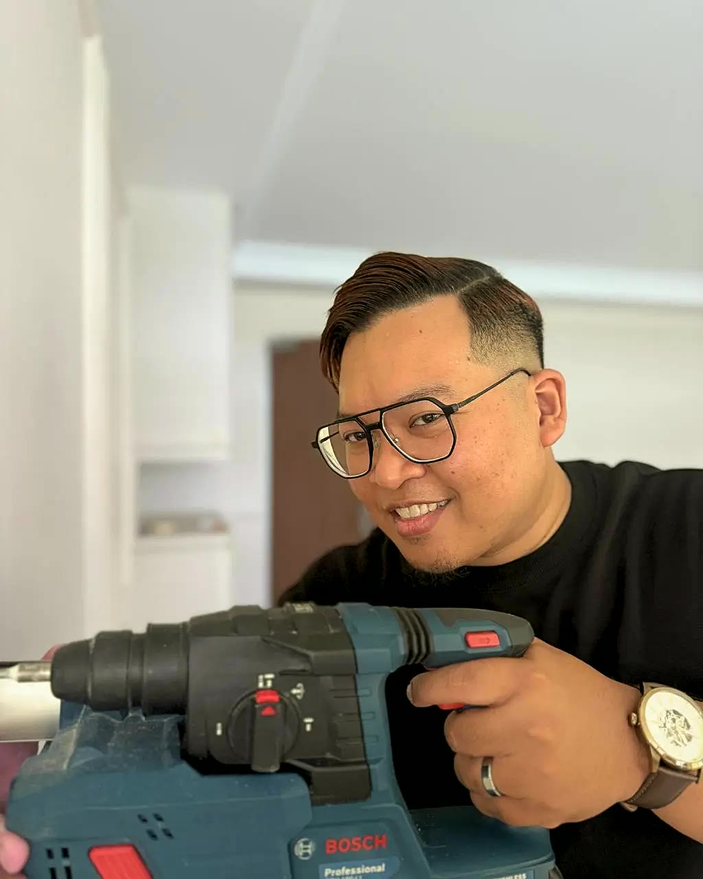 Encik Ahmad, founder of Ceasquare, on site with a rotary hammer drill.